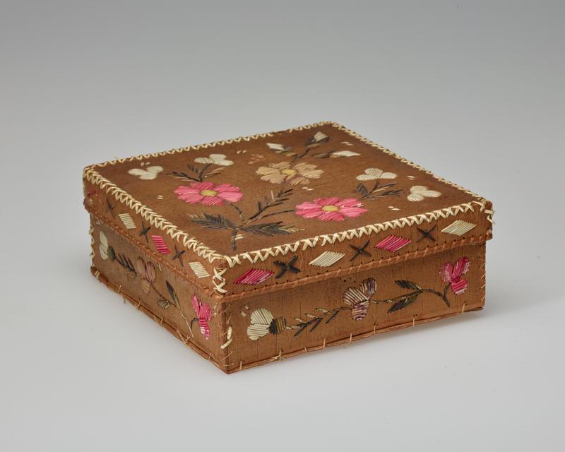 square, rather short box; cover and sides decorated with quillwork flowers in pink, yellow, white and purple with green stems and leaves; edges of cover decorated with pink and white diamonds and brown Xs